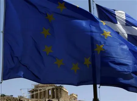A E.U. flag and a Greek flag flutter in front of the monument of Parthenon on Acropolis hill in Athen