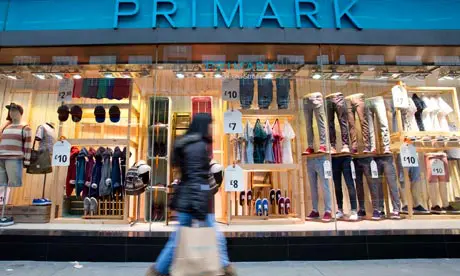 Shoppers walk past a Primark store in London