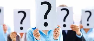 Business people standing with question mark on boards