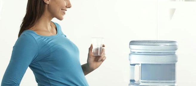 pregnant_office_worker_by_water_cooler_42-16340440