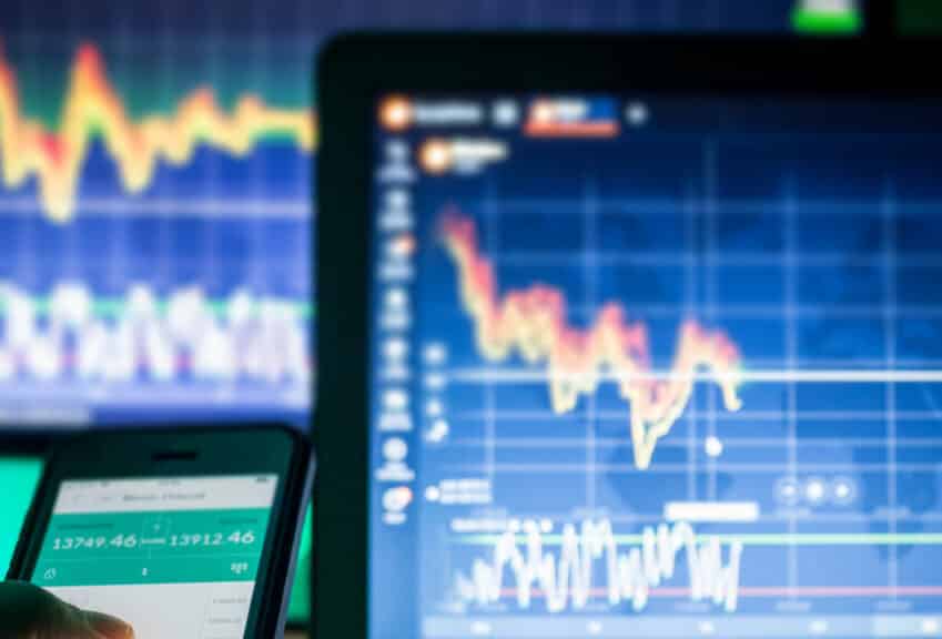 Crypto Currencies, trader using mobile phone and computers